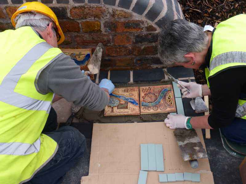 Huw and Ruth laying tiles