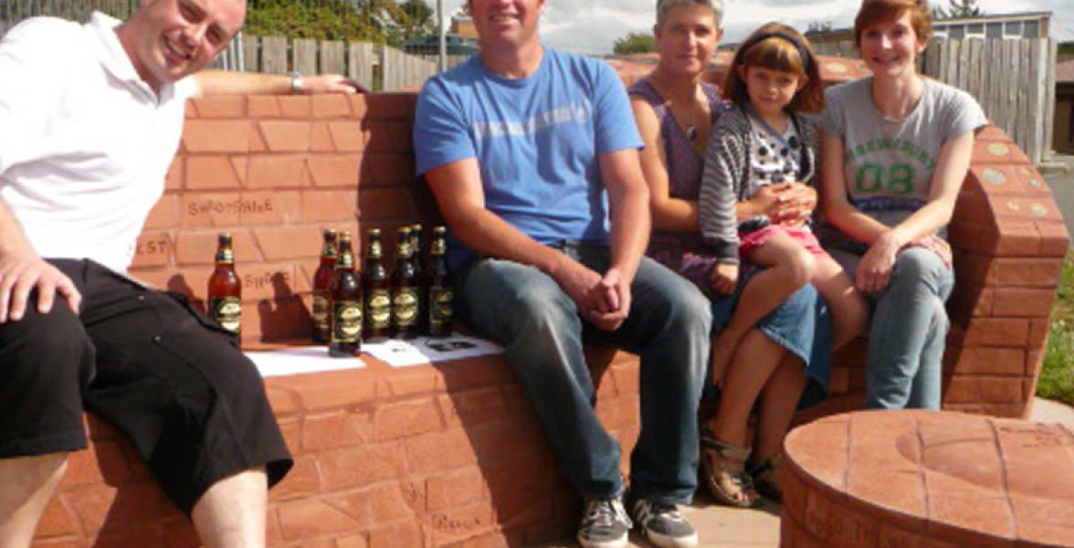 Completed bench with Stuart Dicken brick layer, Monty from Shropshire Radio, Ruth brick artists and daughter Jess with Cait Leach project manager