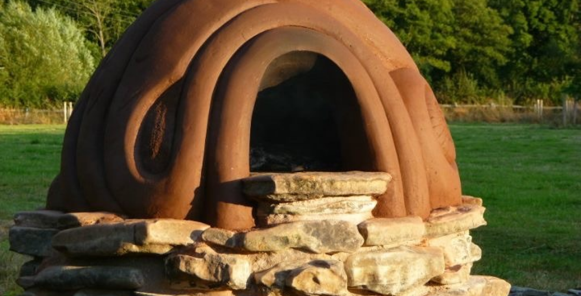 Commission in Onny Meadows - Cob built pizza oven on lime mortared river stone base