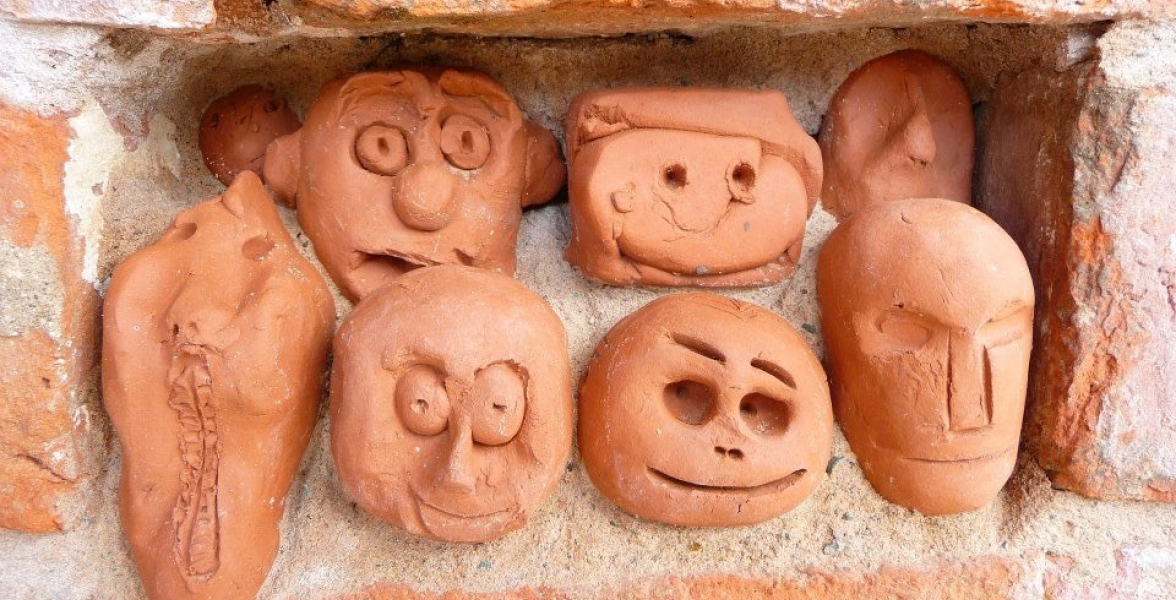 Clay heads in brick work