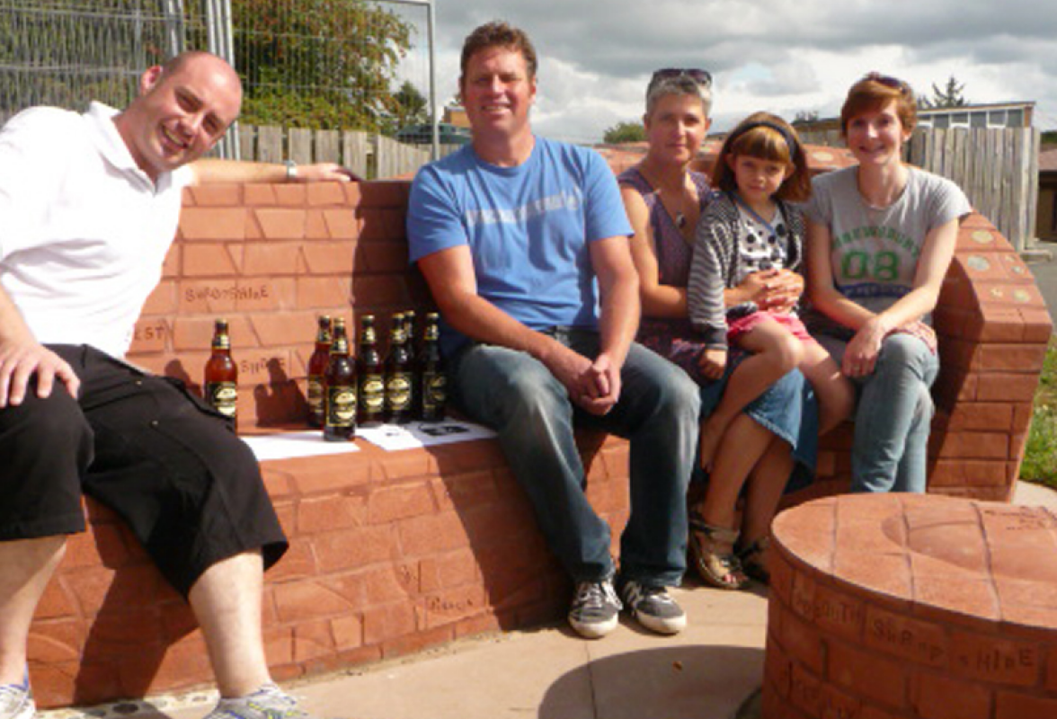 Completed bench with Stuart Dicken brick layer, Monty from Shropshire Radio, Ruth brick artists and daughter Jess with Cait Leach project manager