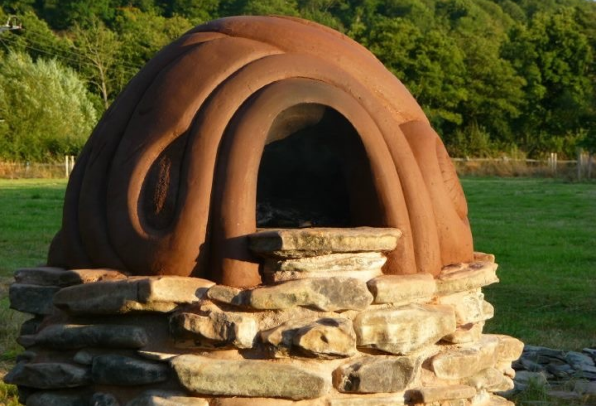 Commission in Onny Meadows - Cob built pizza oven on lime mortared river stone base