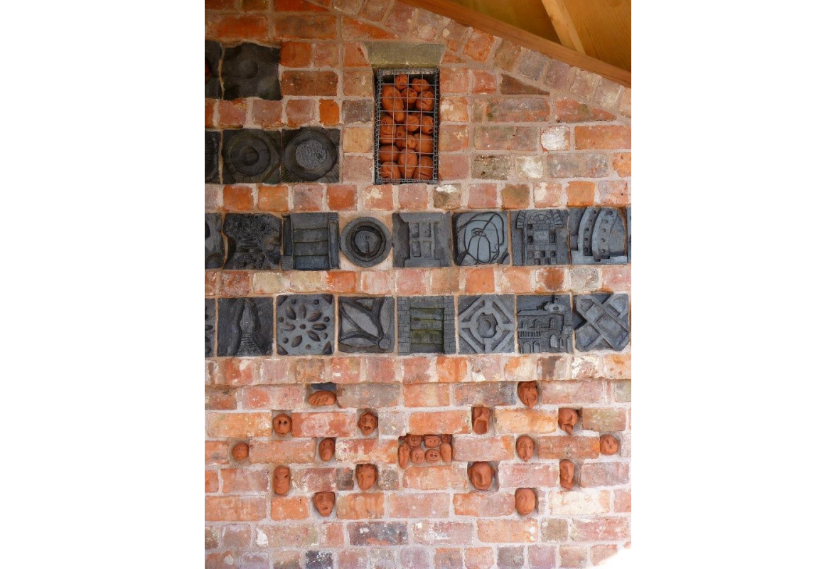Detail of brick carvings and heads made in ceramic workshops