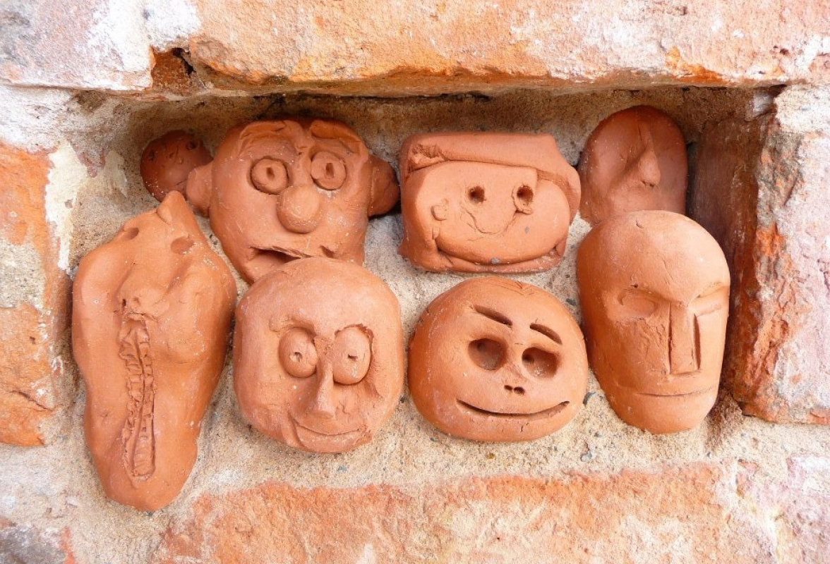 Clay heads in brick work