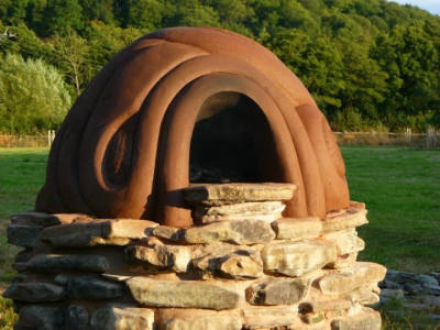 Commission in Onny Meadows - Cob built pizza oven on lime mortared river stone base