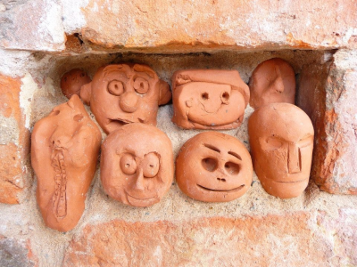 Clay heads in brick work