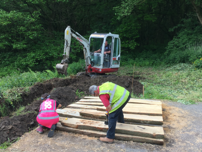 Mini digger digging trench